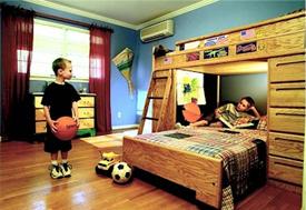 A child enjoys cool, comfortable bedroom provided by Mitsubishi's very quiet mini split wall-mounted indoor unit