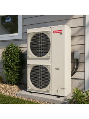 Goodman 21 SEER2 variable speed inverter heat pump condenser installed outdoors on a concrete condenser pad next to a home